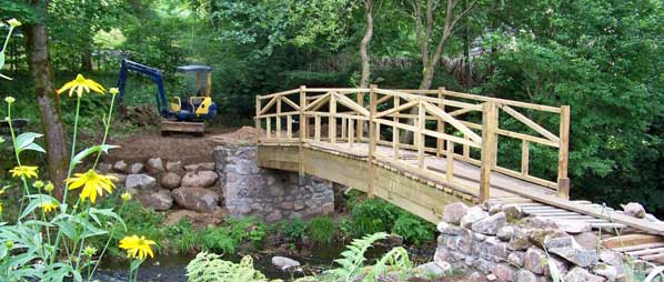 Wooden bridge can look very attractive and enhance a old brook crossing.